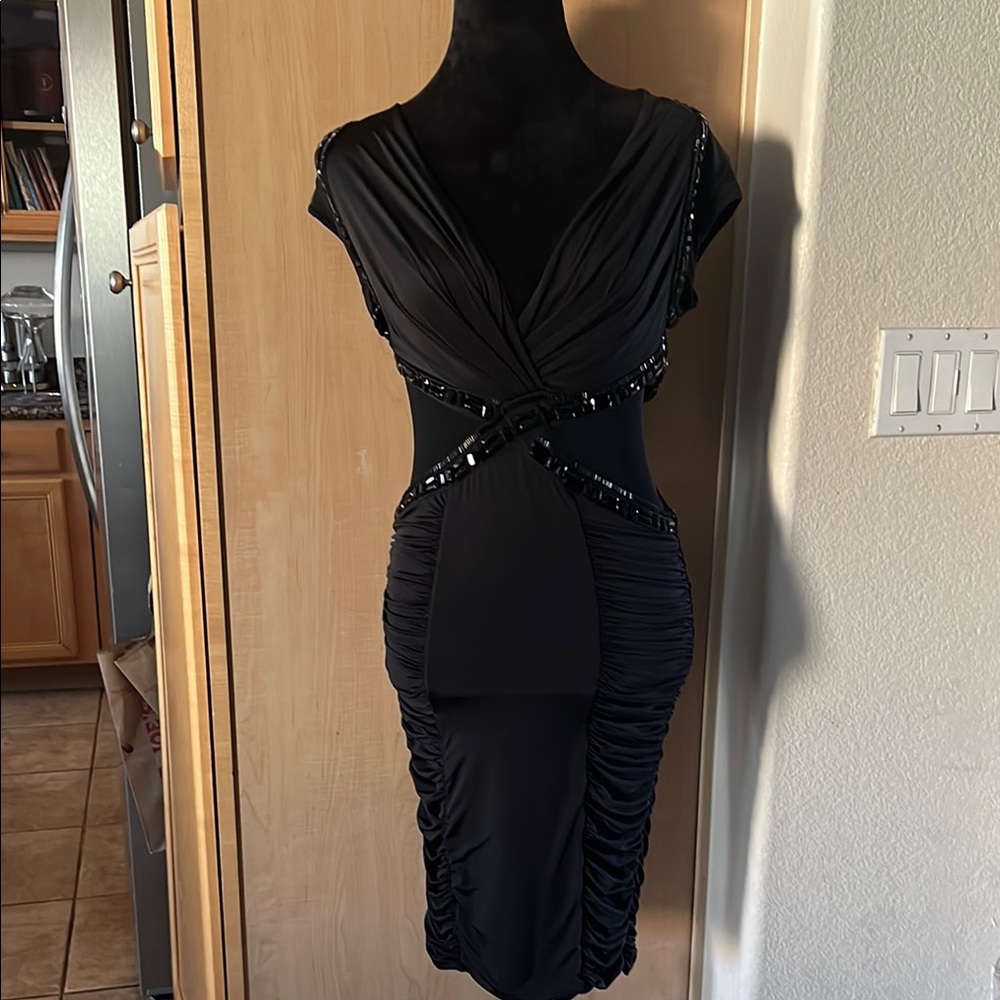 Elegant Black Dress from boutique never worn. Sides and back are see through.